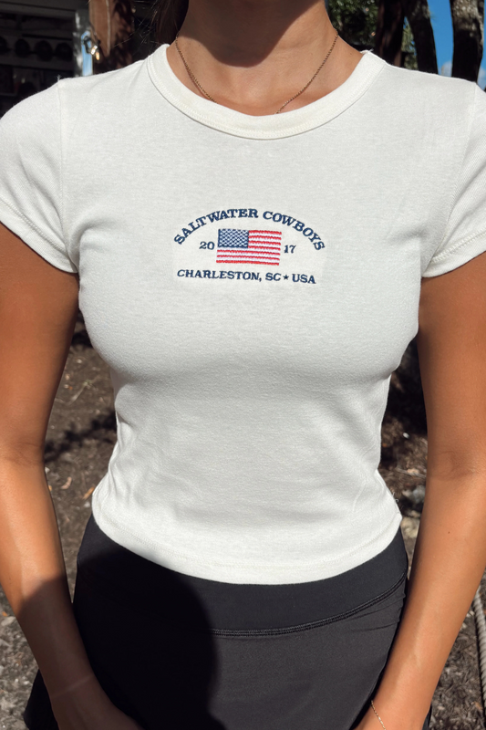 Person wearing a white t-shirt with 'Saltwater Cowboys' logo and text.